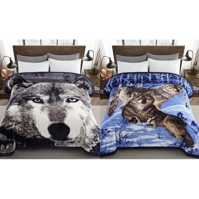 Oversized reversible plush fleece blanket featuring a close-up wolf face design on one side and two wolves in a snowy forest pattern on the reverse, shown spread over a bed with white pillows.