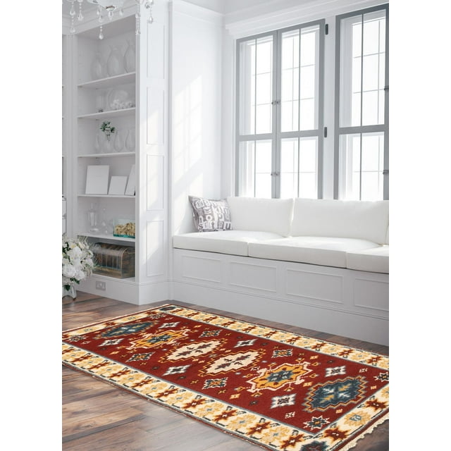 ECARPETGALLERY 100% Wool Traditional Indoor Area Rug with bold geometric Persian Kazak-inspired patterns in red, cream, blue, and yellow tones, placed on hardwood floor in a bright living room featuring white built-in bench seating and large windows, ideal for entrance, bedroom, or dining room.