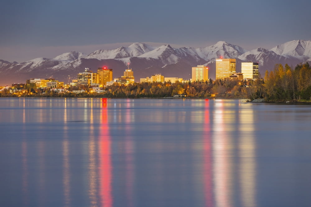 The Anchorage Skyline with the city lights reflected in the water of Knik Arm at high tide Snow covered Chugach Mountain in the background Knik Arm Cook Inlet Anchorage Southcentral Alaska USA Canvas