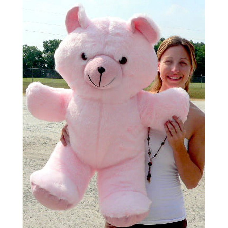 Premium Photo  A pink teddy bear with a big smile on its face.