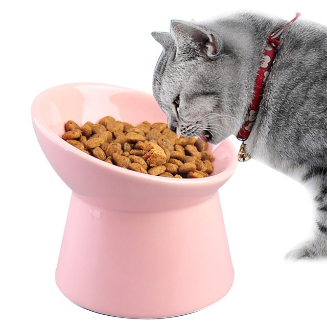 Elevated Pet Bowl Neck Protection Ceramic Cat Bowl Cat Water Bowl for Kitten in pink color. The ceramic bowl features a tilted design for neck protection, reducing strain while eating or drinking. It has a top diameter of 120mm (4.72in), bottom diameter of 100mm (3.94in), and height of 100mm (3.94in). A grey cat is shown eating from the bowl, which is suitable for kittens, puppies, and other small pets. The bowl is non-slip and durable.