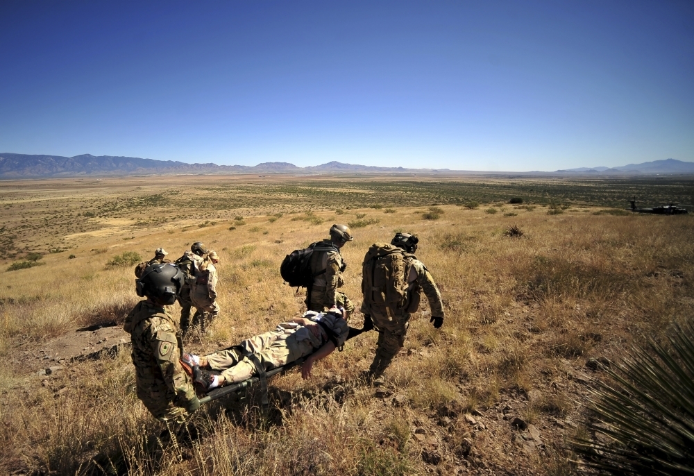 U.S. Air Force Pararescuemen carry litter patients Poster Print (17 x