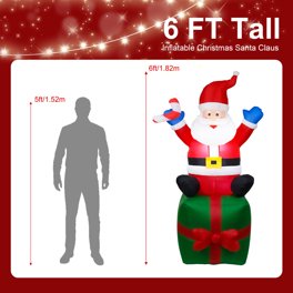 Structure de Noël gonflable : Père Noël assis sur un cadeau