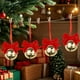 thumbnail image 1 of Adornos navideños con campanas de terciopelo rojo y lazos de hierro forjado para crear un ambiente festivo., 1 of 5
