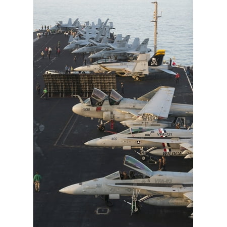 Aircraft parked on the flight deck of USS Dwight D Eisenhower at the end of another flying day in the Arabian Sea during Operation Enduring Freedom operations Poster