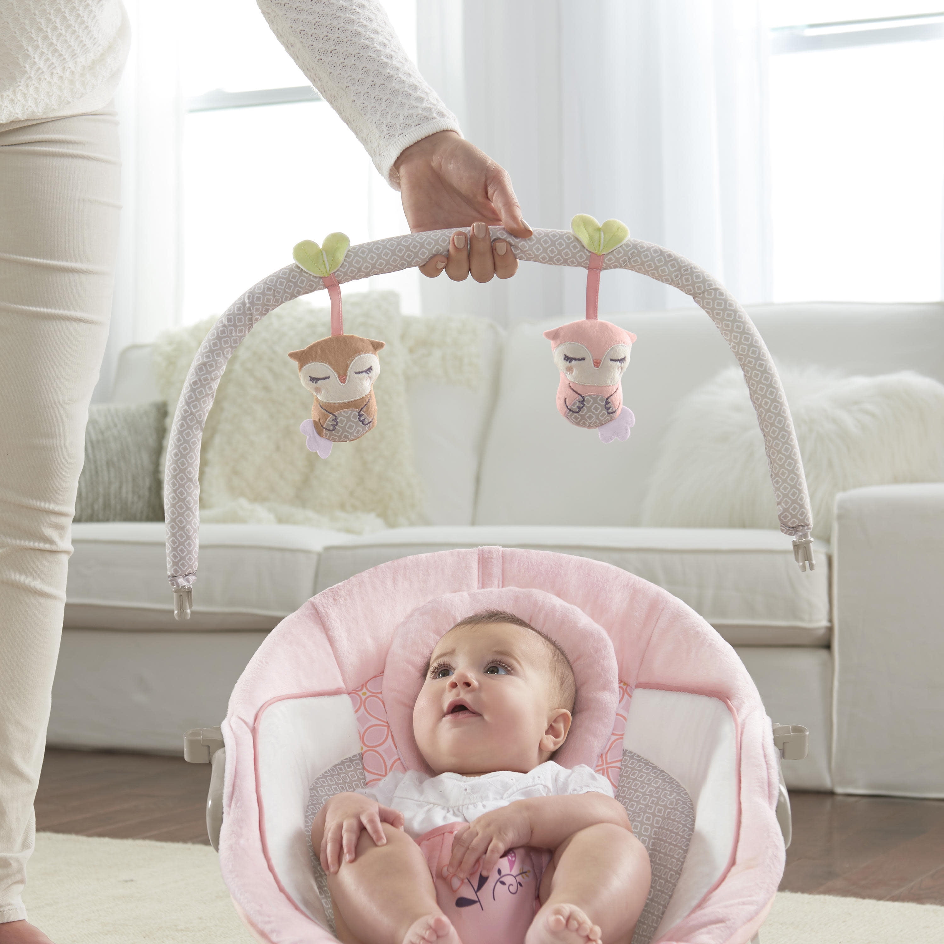 audrey cradling bouncer in pink