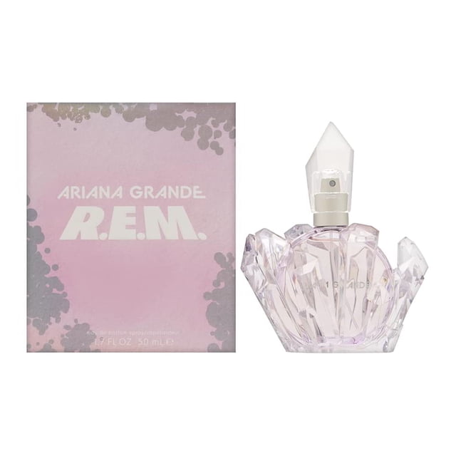 r.e.m. by ariana grande eau de parfum spray 1.7 oz r — frasco facetado tipo gema de vidrio translúcido con líquido rosa pálido y tapa cónica blanca, mostrado frontalmente junto a caja rosa con texto blanco y detalles grisáceos; suele utilizarse como perfume de diario o como detalle de regalo.