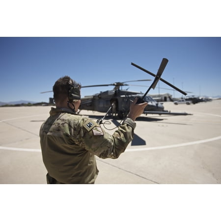 Pararescuemen conducts a communications check with his Sat radio at ...