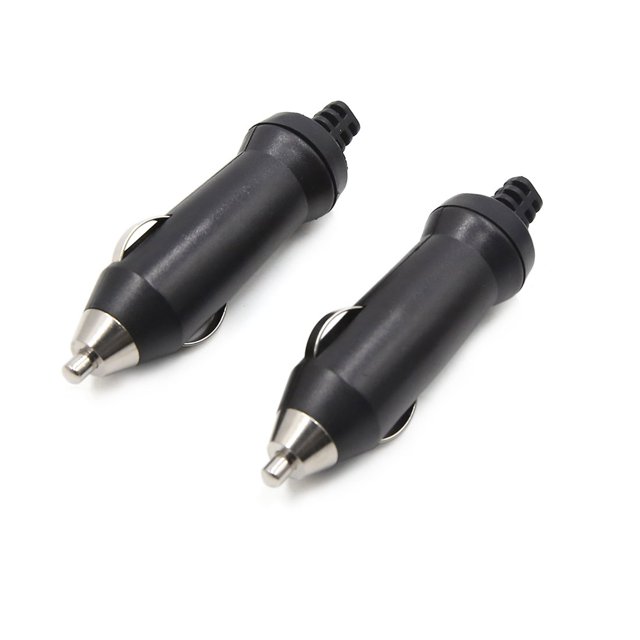 Unique Bargains 2pcs 12-24V Car Lighter Charger Socket Power Plug Outlet Adapter. The image shows two black and silver-tone car cigarette lighter adapters with a durable plastic and metal construction. These adapters are designed for high heat resistance, insulation, and corrosion resistance. They are suitable for powering on-board electrical appliances like vacuum cleaners, inflatable pumps, and car washers. Each adapter measures 8.4 x 2 cm (3.3 x 0.8 inches) and plugs directly into a 12-24V cigarette lighter socket.