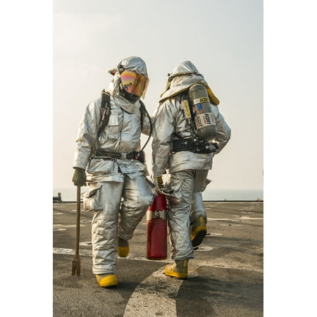 - LAMINATED POSTER Crash and salvage team members walk front to back during a flight deck crash drill on the flight de Poster Print 24 x 36
