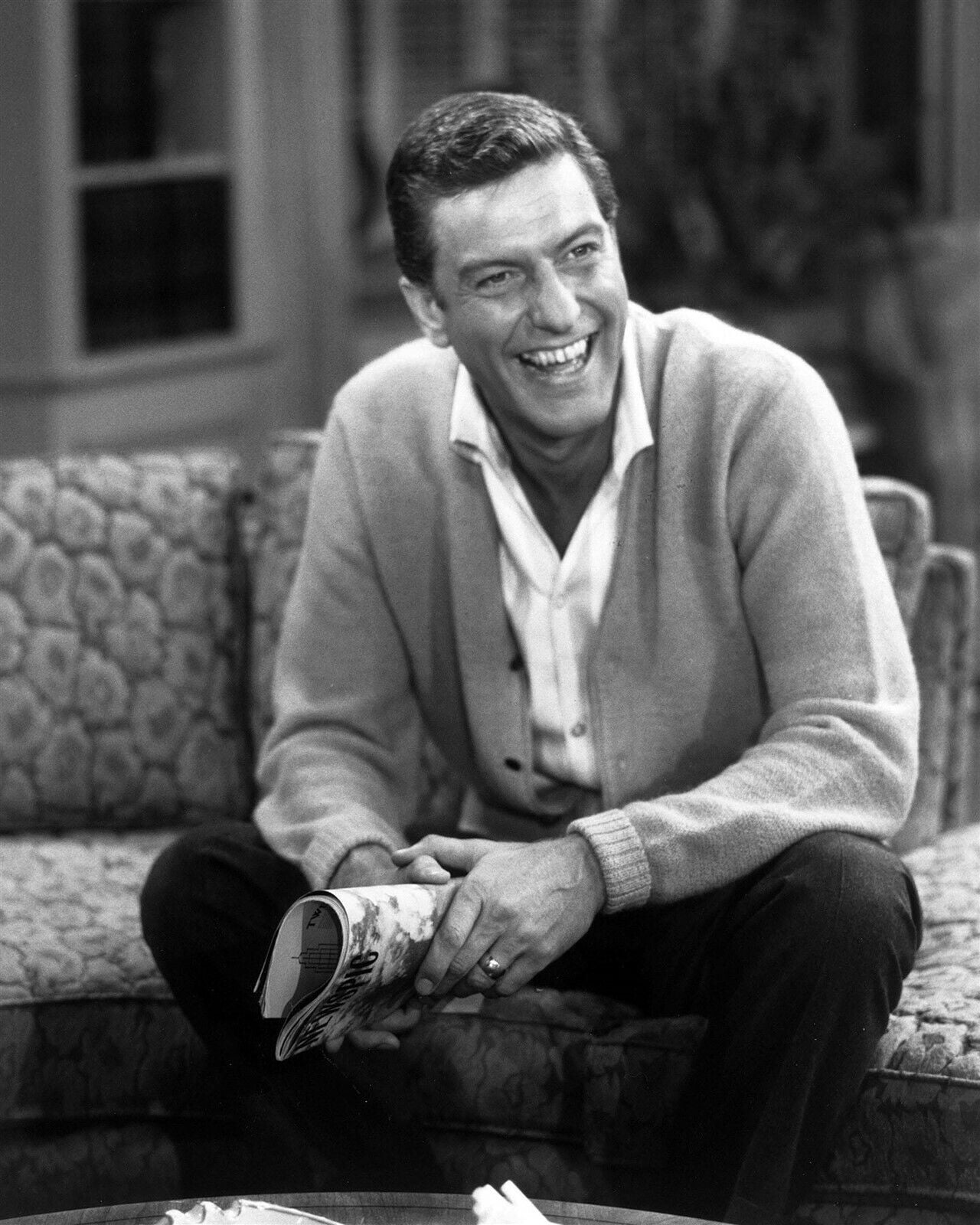 Dick Van Dyke laughing as Rob petie seated on sofa Dick Van Dyke Show