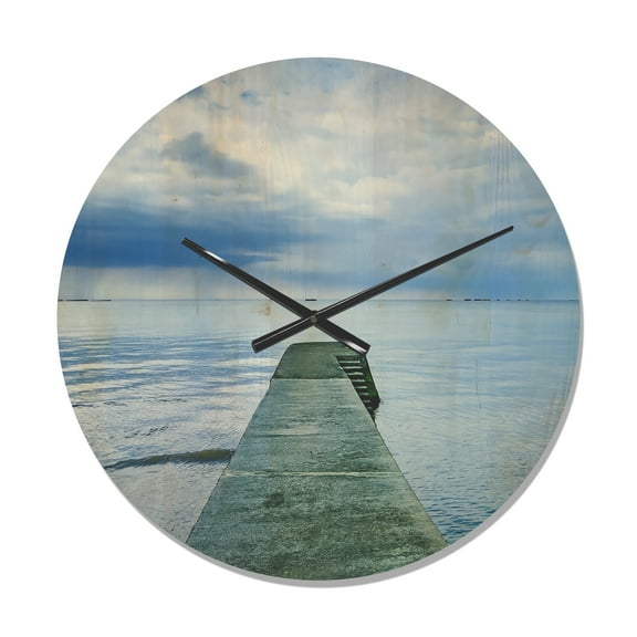 Designart 'Concrete Lake Pier Under Cloudy Sky ' Modern Wood Wall Clock