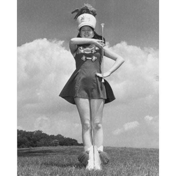 Low angle view of a drum majorette performing with a twirling baton in