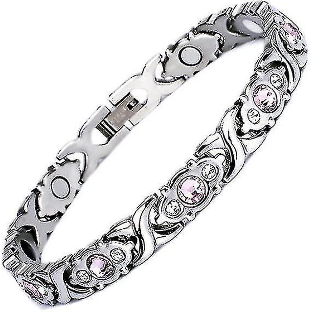 pulsera para revivir la menopausia con terapia magnética para mujeres Pulsera plateada con eslabones ornamentales y cristales rosa incrustados, cierre plegable y superficies pulidas; interior con placas magnéticas según la descripción del producto, vista en diagonal sobre fondo blanco; también se usa como accesorio de moda.
