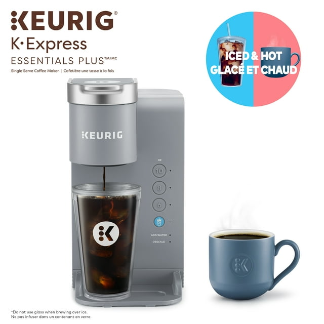 Keurig K-Express Essentials Plus single serve coffee maker brewing iced coffee into a clear branded glass, accompanied by a blue mug of hot black coffee, highlighting its ability to brew both iced and hot beverages.