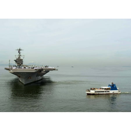 LAMINATED POSTER A ferry transports media to document the aircraft carrier USS George Washington dropping anchor as t Poster Print 24 x