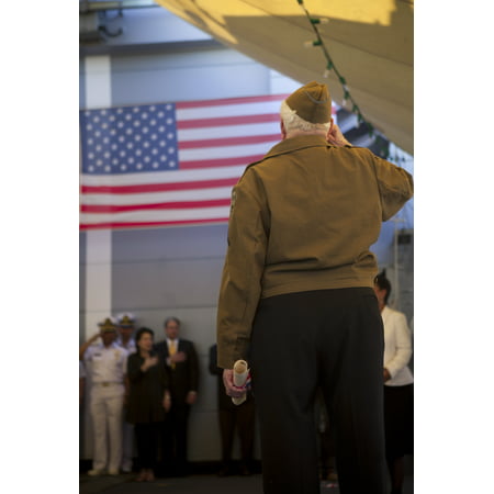 LAMINATED POSTER Leon C. Standifer, a World War II veteran, salutes during the national anthem played after he receiv Poster Print 24 x