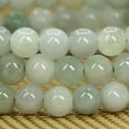 thumbnail image 3 of Angelstones Bracelet Extensible Unisexe en Perles Rondes de 6 mm en Jade Vert Naturel et Blanc 7 Pouces, 3 of 5