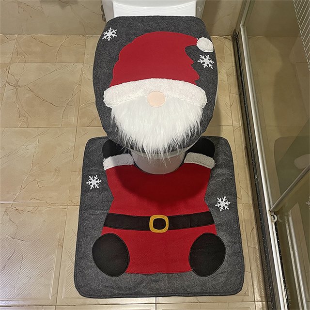 fiudx juego de baño navideño con diseño de anciano sin rostro, set de alfombrillas y cubre asiento en tela no tejida, vista frontal cenital centrada mostrando gorro rojo y barba blanca de felpa, traje rojo con cinturón negro y hebilla amarilla, copos de nieve aplicados sobre fondo gris; medidas 42 x 36 cm y 54 x 54 cm, para decoración de baño en hogar, comercio u hotel, fácil de limpiar. A menudo usado también como adorno estacional para vestíbulos o áreas pequeñas de recepción.