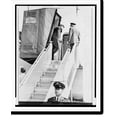 thumbnail image 2 of Historic Framed Print, President Kennedy, his movements restricted by back injury, is hoisted to plane in a special lift, left. At door level, right, he uses crutches to enter, 17-7/8" x 21-7/8", 2 of 9