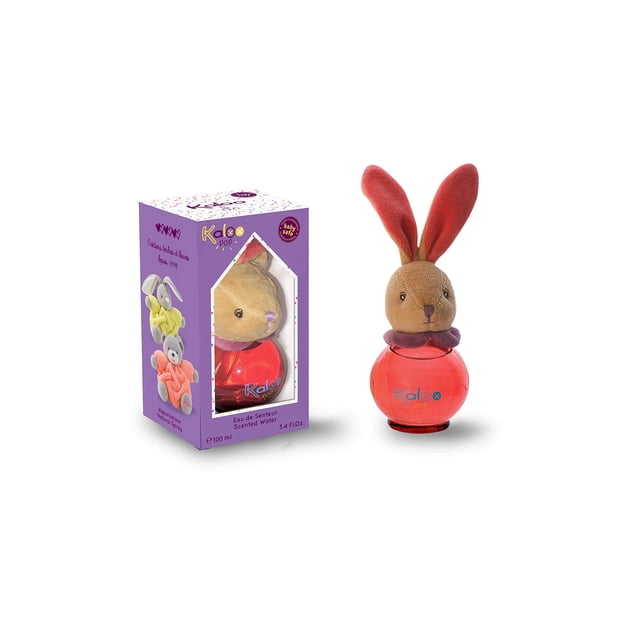 perfume kaloo fragrance pop/afrutado sin alcohol, 100 ml — botella redonda rojo coral de 3.4 onzas líquidas con tapa de felpa en forma de conejo marrón y orejas largas; vista frontal junto a su caja morada con ventana que muestra el mismo frasco; indicado para bebé, apto para rociar en manos, sábanas o la habitación.
