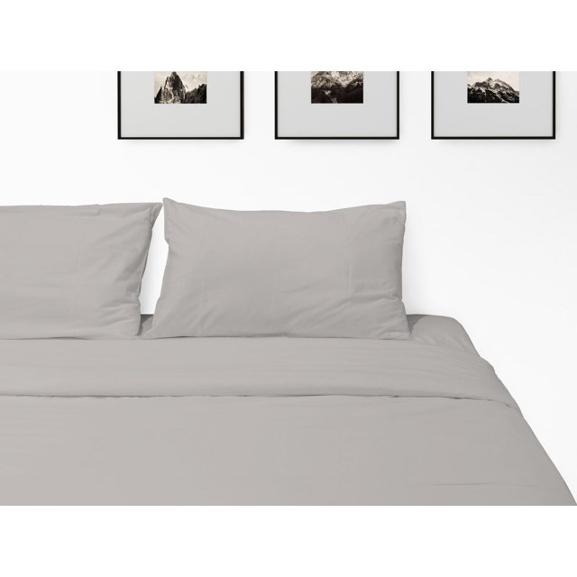 Johnson Home 500 thread count certified organic cotton sheet set in light gray displayed on a neatly made bed with matching pillowcases and minimalist mountain artwork above.