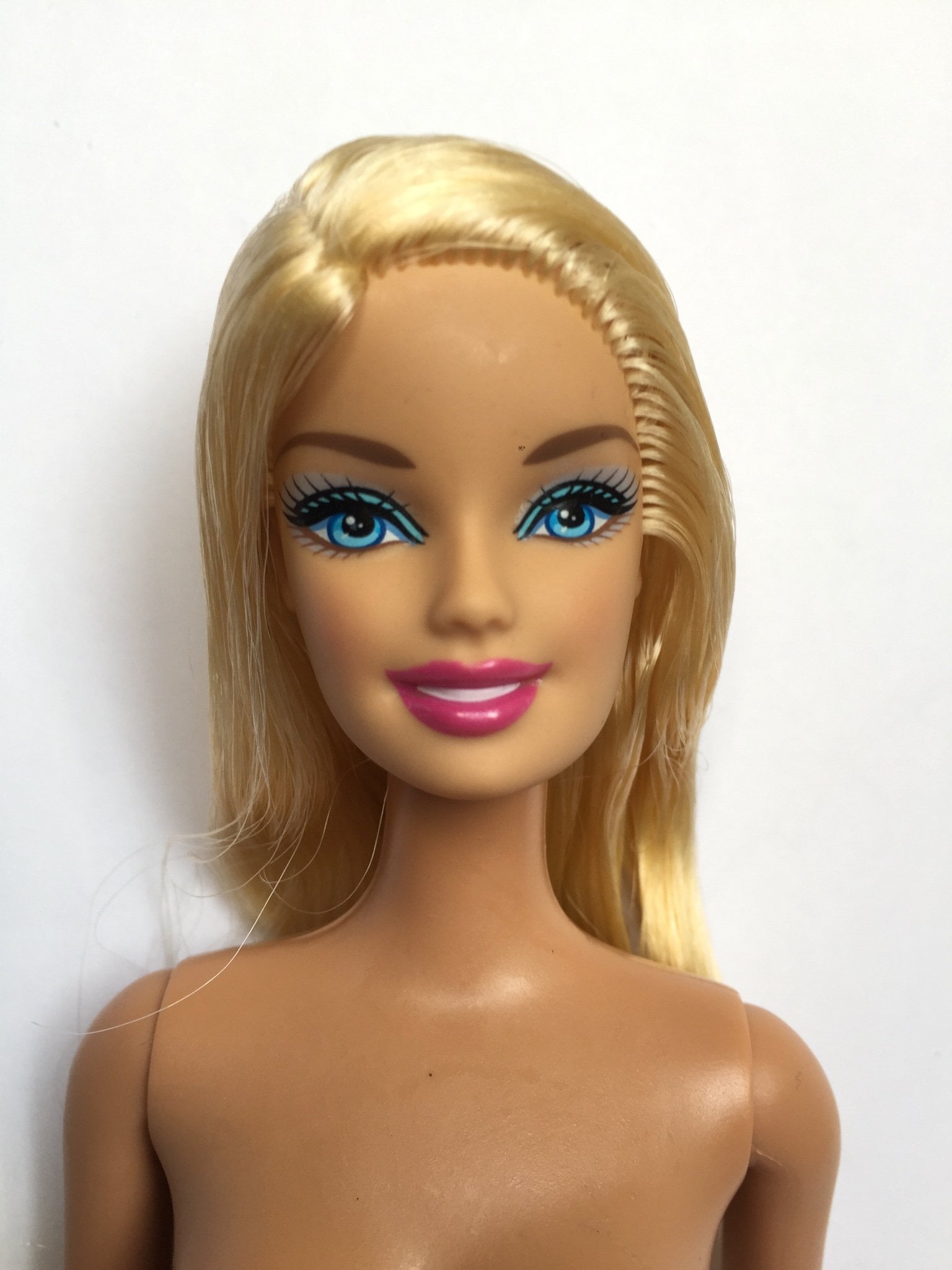 doll with pink hair and button eyes