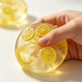 thumbnail image 2 of Lemon Squishy Squeeze Toy, Transparent Plastic Ball With Embedded Slice for Tactile Hand Fidget Play, 2 of 6
