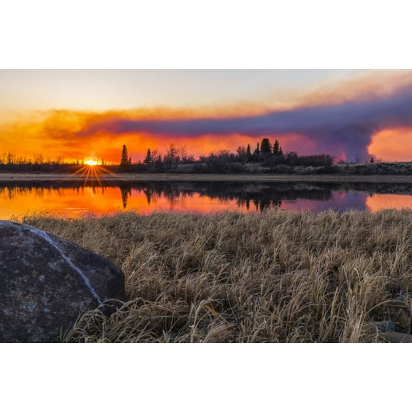 A plume of smoke rising from the 2019 Oregon Lakes fire reflects in a lake at sunset, south of Delta Junction; Alaska, United States of America Poster Print by Steven Miley (38 x 24) # 12573799