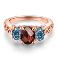 thumbnail image 3 of Gem Stone King 18K Rose Gold Plated Silver Red Garnet and Persian Blue Moissanite Filigree Style 3 Stone Ring for Women (2.43 Cttw, Oval 8X6MM and 6X4MM) (Size 8), 3 of 6