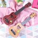 thumbnail image 3 of Juguete para tocar con cuatro cuerdas (44cm, marrón) de mini guitarra de ukelele imitada para niños, con instrumentos musicales pequeños., 3 of 5