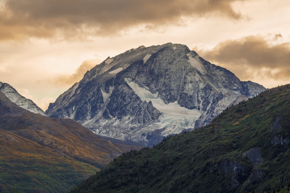 A dusting of snow coats a peak in the Chugach Mountains in the late part of summer as the alpine begins to change to autumn colours Valdez Alaska United States of America Canvas Art - Zachary Sheldon