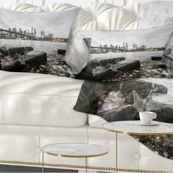 Designart Brooklyn Bridge with Rocks on Shore - Cityscape Throw Pillow - 12x20