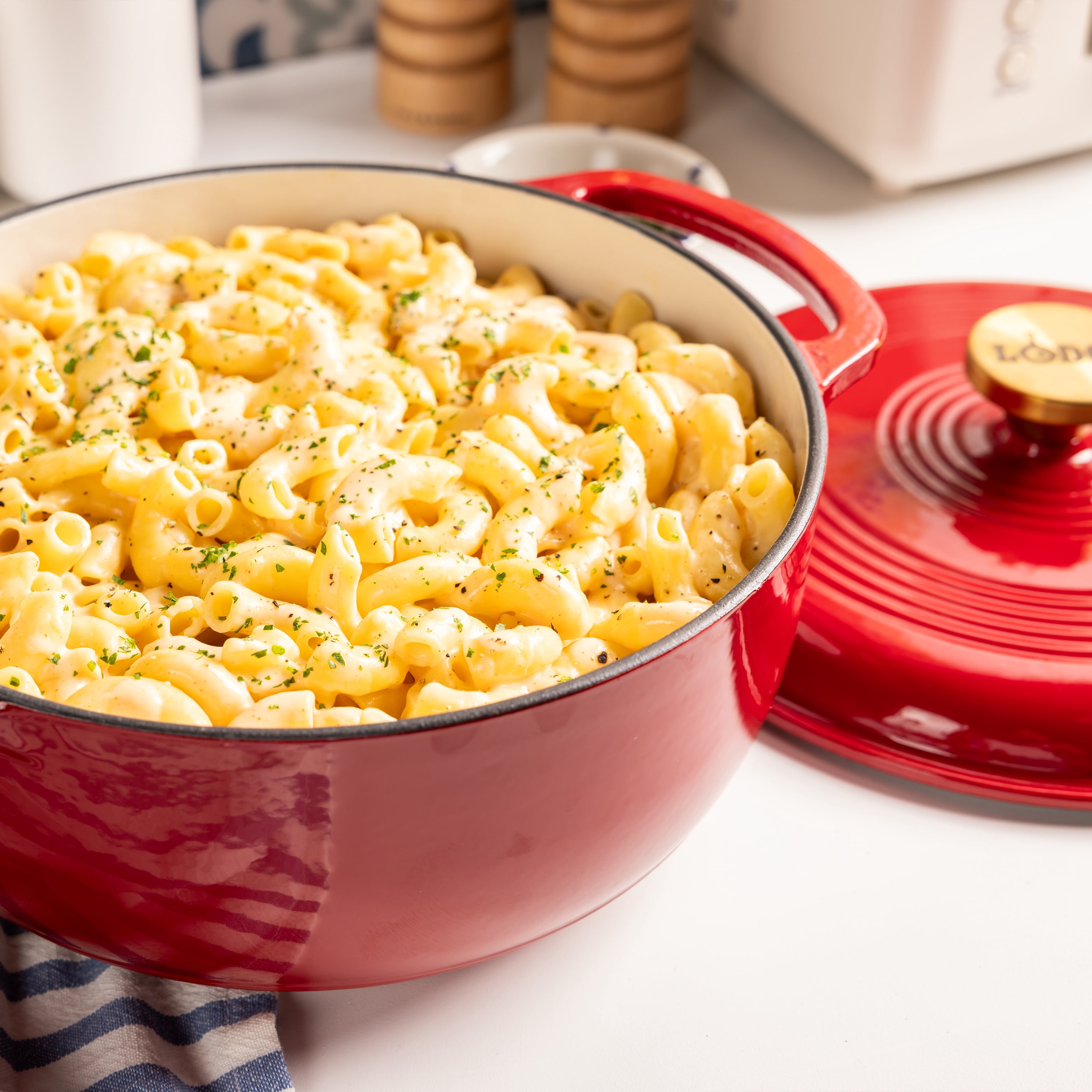 Lodge 4.5 Quart Enameled Cast Iron Dutch Oven with Lid – Dual Handles – Oven Safe up to 500° F or on Stovetop - Use to Marinate, Cook, Bake, Refrigerate and Serve – Ruby with Gold Knob