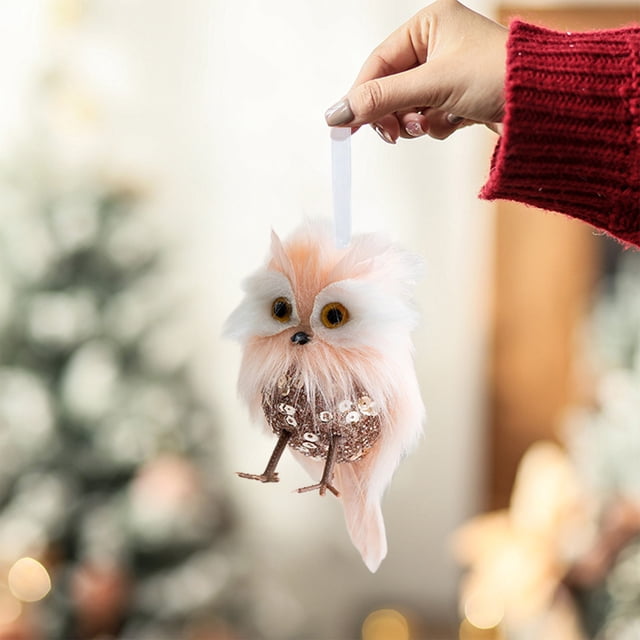 christmas tree hanging decoration felts material holiday decoration hanging decoration christmas tree window decoration Multicolor felts festival pendant shaped like a small owl with fluffy white and peach felt head and tail, round glittery body, yellow eye details and small beak, white hanging ribbon; centered front view held by hand against a blurred indoor Christmas tree background, suitable for hanging on trees or windows and often used as a seasonal gift.