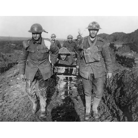 World War I Soldiers Nbringing A Wounded Canadian Soldier Through The Mud Somewhere In France Poster Print by Granger Collection