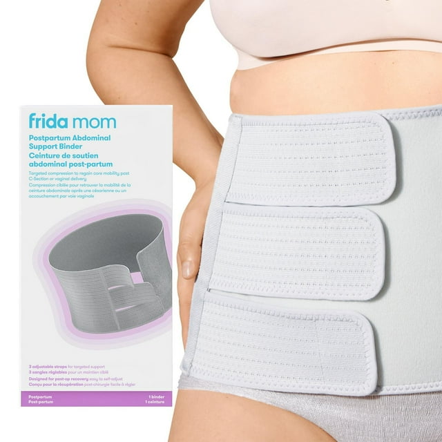 Frida Mom postpartum abdominal support binder with three adjustable straps shown on a person’s abdomen alongside the product packaging highlighting targeted compression for post-C-section and vaginal delivery recovery.