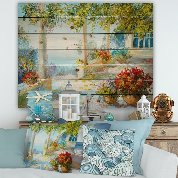 Designart 'Terrace With Red Flowers Near The Sea' Nautical & Coastal Print on Natural Pine Wood