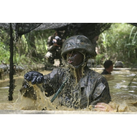 A Marine splashes as he makes his way through an obstacle course at the Jungle Warfare Training Center Canvas Art - Stocktrek Images (34 x
