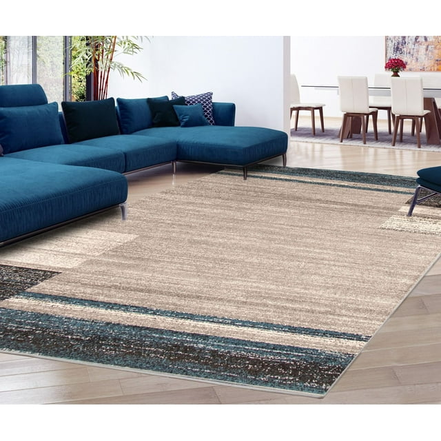 soft and plush ECARPET Ayla Collection area rug with beige center and blue border placed in a contemporary living room featuring a blue sectional sofa