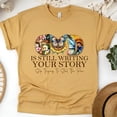 thumbnail image 1 of God Is Still Writing Your Story Christian T-Shirt Faith Graphic Tee, Gold, Size L, 1 of 6