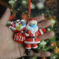 thumbnail image 4 of Estatua navideña pequeña de Papá Noel con mascarilla que lleva herramientas de limpieza, 4 of 5