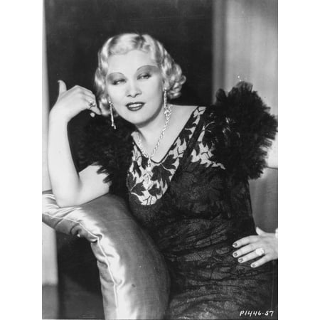 Mae West sitting in Black Dress with Hand on Hips Photo