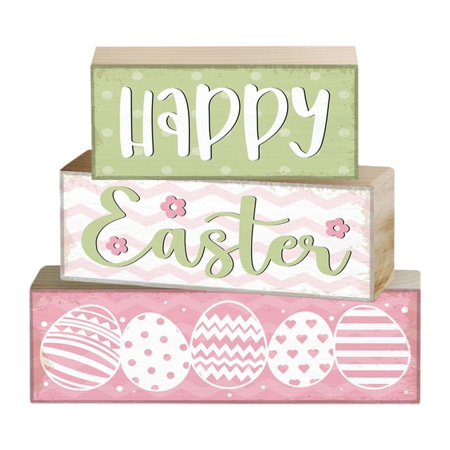 3x letrero de mesa de mesa de pascua de madera interior para decoración del hogar decoraciones de mesa de pascua versátiles para sala de estar de huevos de pascua set de tres bloques apilables, vista frontal; bloque superior verde con "HAPPY" en blanco, bloque central blanco con "Easter" en script verde y florcitas, bloque inferior rosa con seis huevos de Pascua blancos con patrones, textura de madera pintada visible, tamaños 9, 12 y 15 cm de ancho x 5 cm de alto, apto para sala, repisa o regalo de Pascua.
