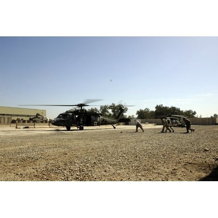 Soldiers Rush A Simulated Casualty To A Uh 60 Blackhawk Helicopter