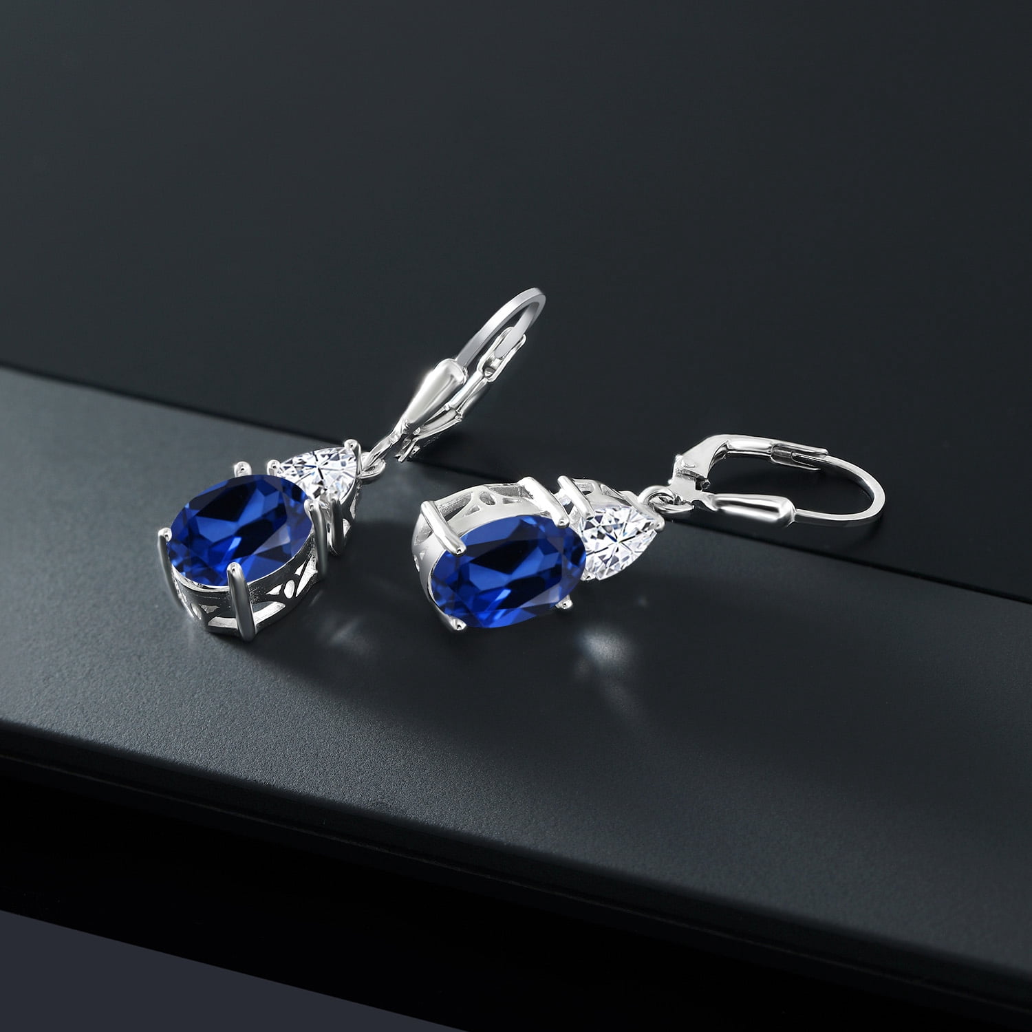 Gem Stone King 925 Sterling Silver Blue Created Sapphire and White Moissanite Dangle Earrings for Women (7.54 Cttw, Gemstone September Birthstone, Oval 10X8MM, Trillion 5MM)