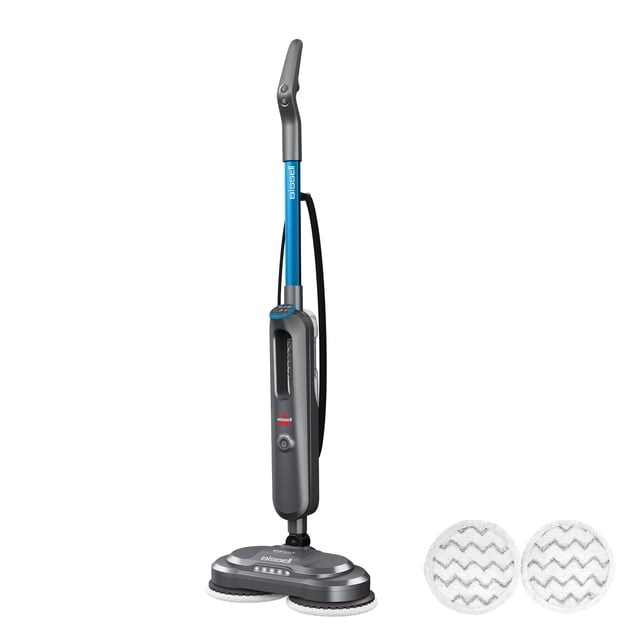 fregadora a vapor bissell spinwave smartsteam con almohadillas, vista frontal 3/4 de limpiadora vertical gris y azul con pantalla LED en la columna, cabezal giratorio con dos almohadillas circulares de microfibra lavables visibles, cable lateral y depósito de agua extraíble sobre fondo blanco; diseñada para pisos duros, niveles de vapor ajustables y faros LED para iluminar zonas; a menudo usada también para refrescar áreas de paso pequeñas.