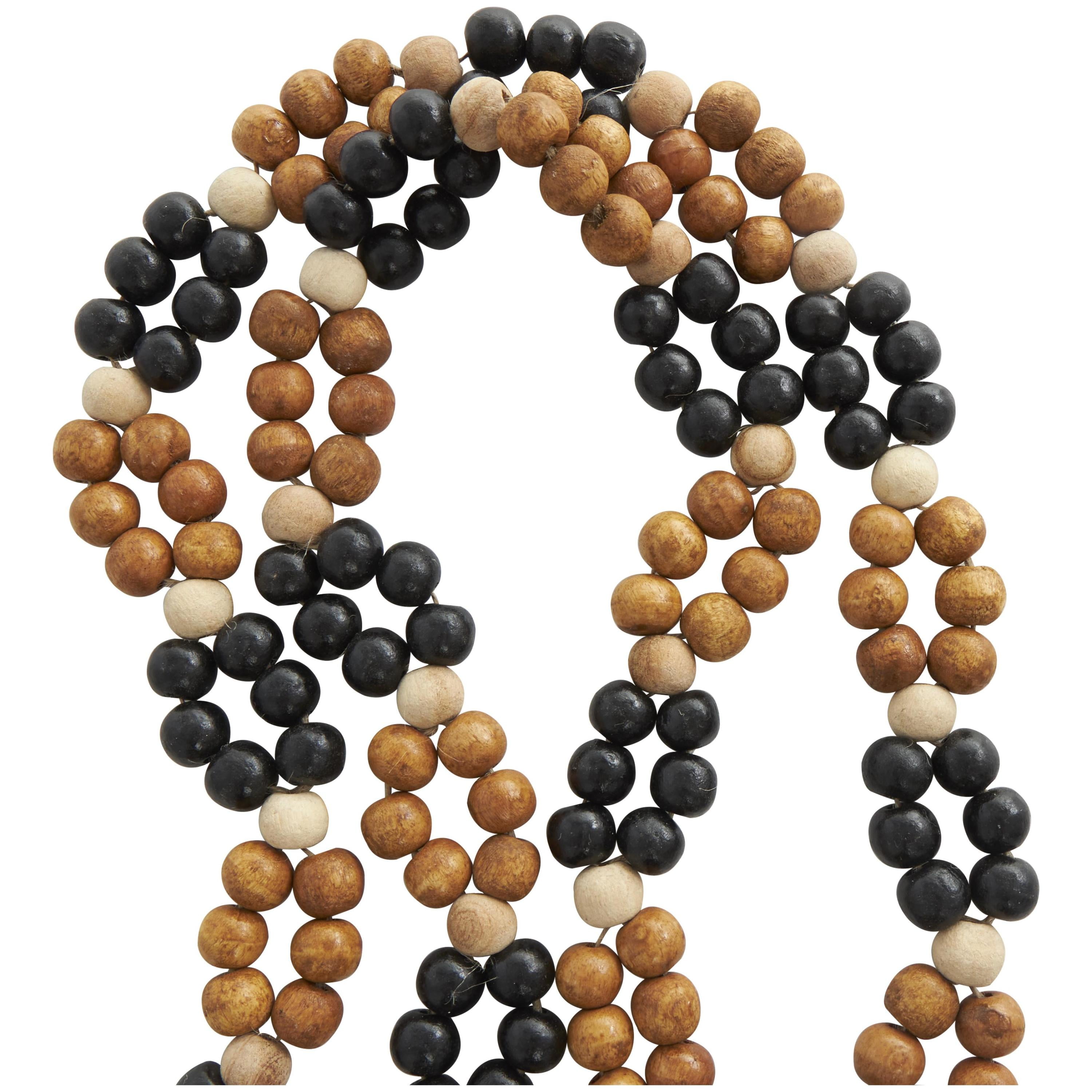 DecMode Handmade Round Double Layered Long Carved Brown Mango Wood Garland with Tassel with Black and Cream Accents