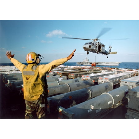Directors Showcase Cotton - Canvas Print At sea aboard USS John F. Kennedy (CV 67) Oct. 4, 2002An aircraft director signals to a MH-60S K Stretched Canvas 10 x 14