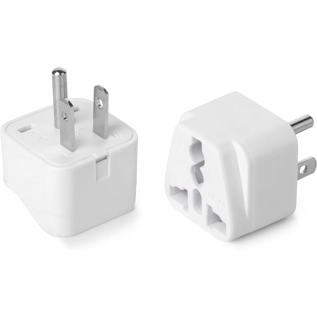 Bates US Plug Adapter, 2-piece set, featuring a compact white design with Type B prongs and universal compatibility for plugs from over 200 countries, including UK, EU, AUS, and CN. The adapters are lightweight and ideal for travel, suitable for charging devices like smartphones, laptops, and tablets. Shown are two adapters, highlighting the prongs and input slots for various plug types.